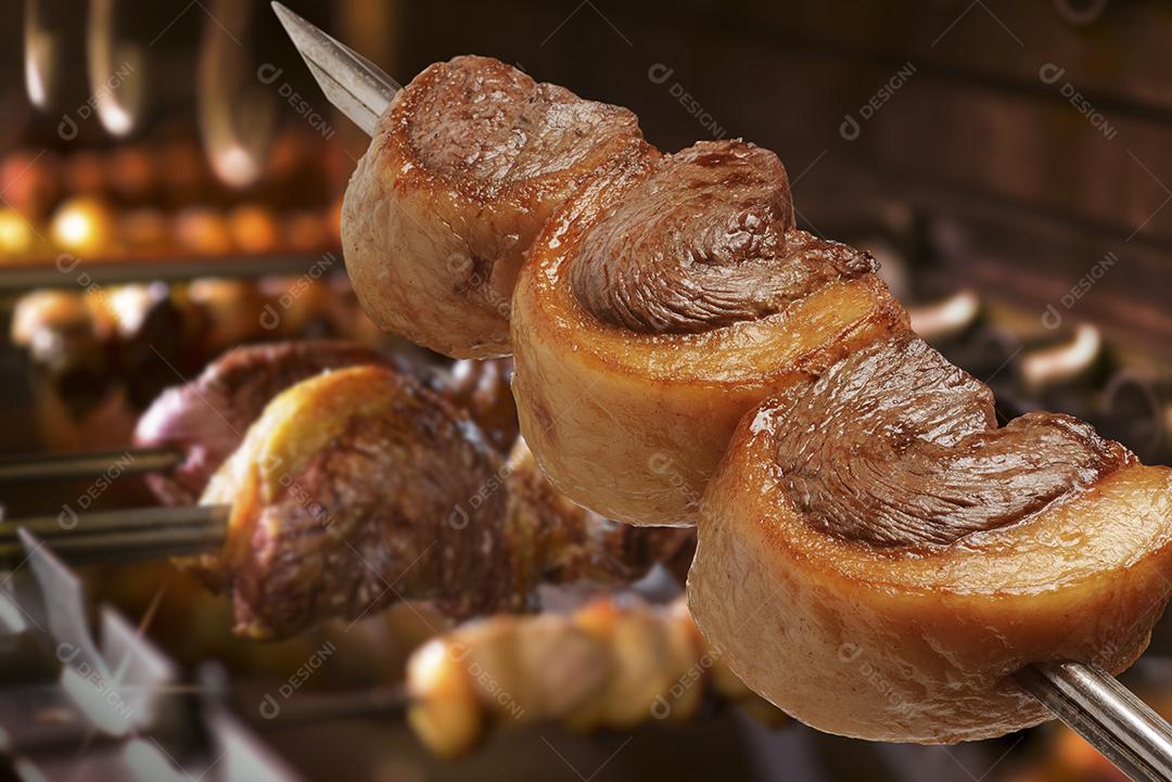Churrasco de picanha assada no espeto na brasa. Esse tipo de churrasco é  amplamente consumido em todo o Brasil [download] - Designi