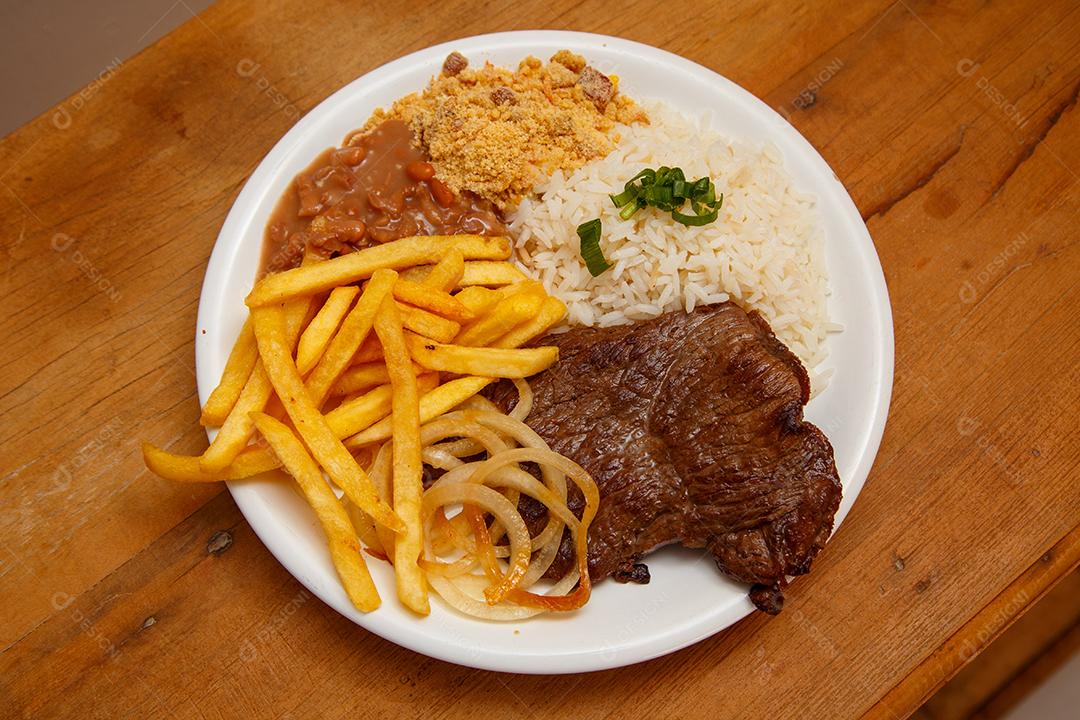 Plate of rice, beans, french fries and steak