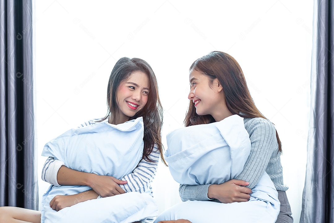 Two Asian lesbian women looking together in the bedroom. Couple of people.