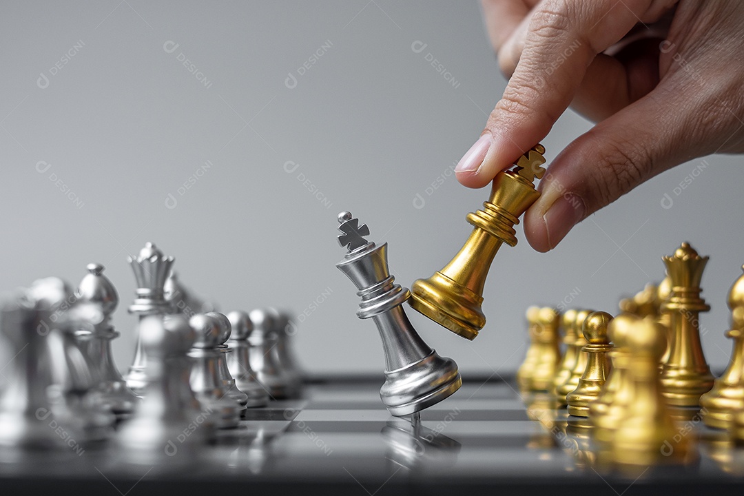 businessman hand moving gold figure Chess King and Checkmate ene