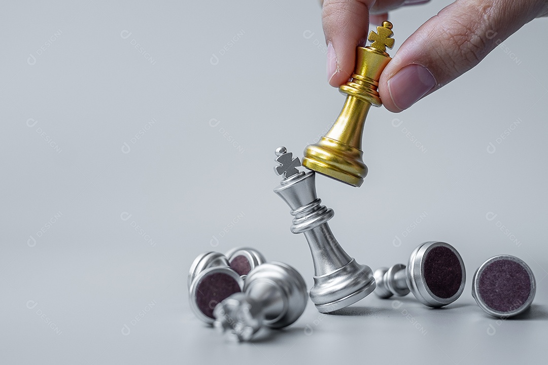 businessman hand moving gold figure Chess King and Checkmate opp