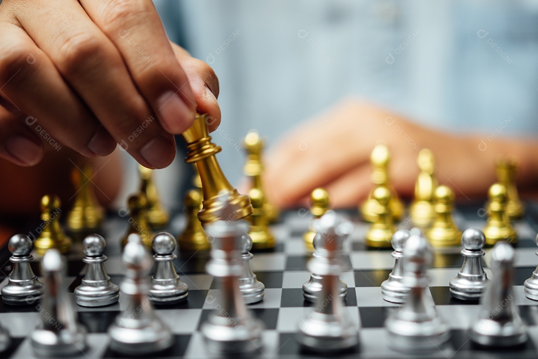 Businessman's hand moving chess figure in competition success game.