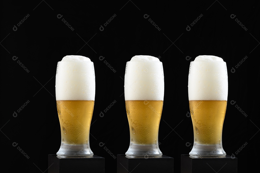 Three glasses of beers on black background