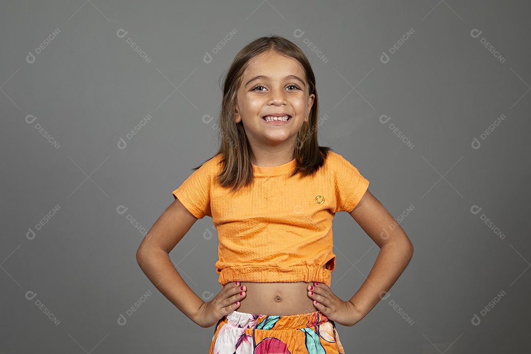 Beautiful girl dressed in colorful clothes with hands on the waist