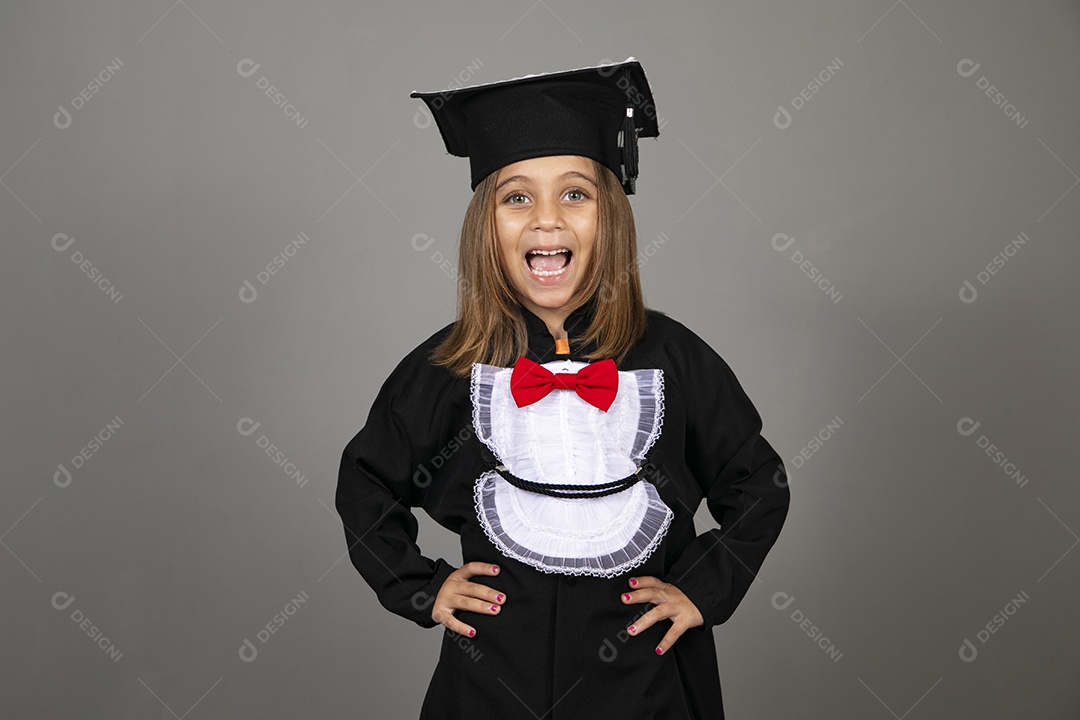 Beautiful little girl using graduation beak