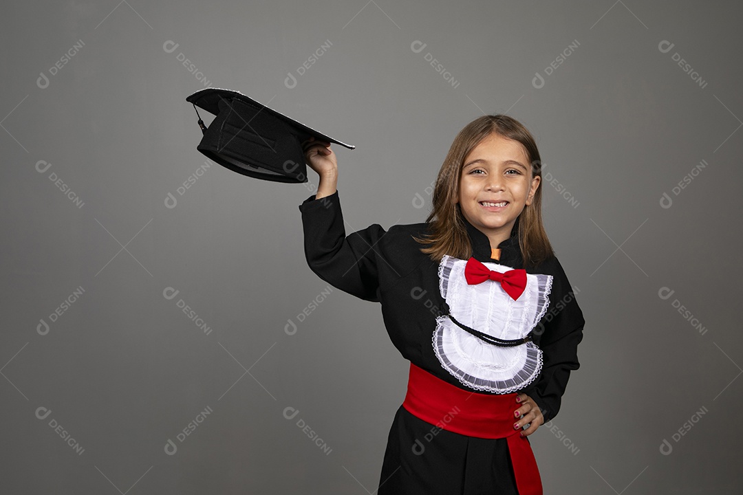 Beautiful girl holding capelo with graduation clothes