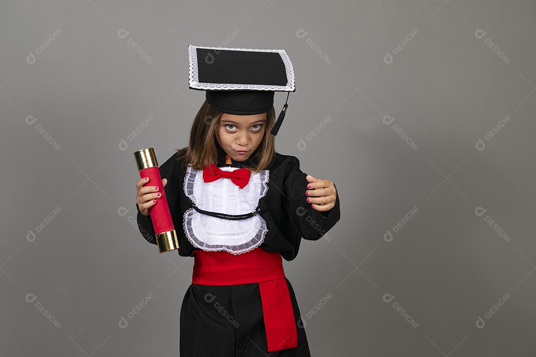 Little girl doing pose with graduation costumes