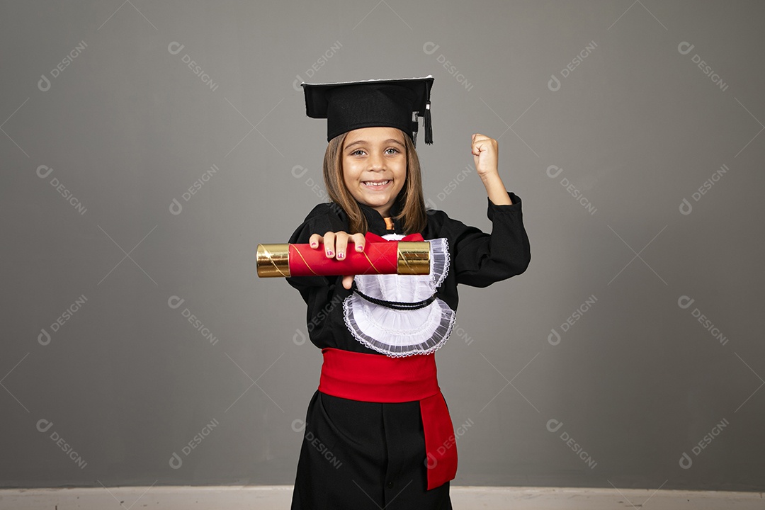 Beautiful little girl using graduation beak