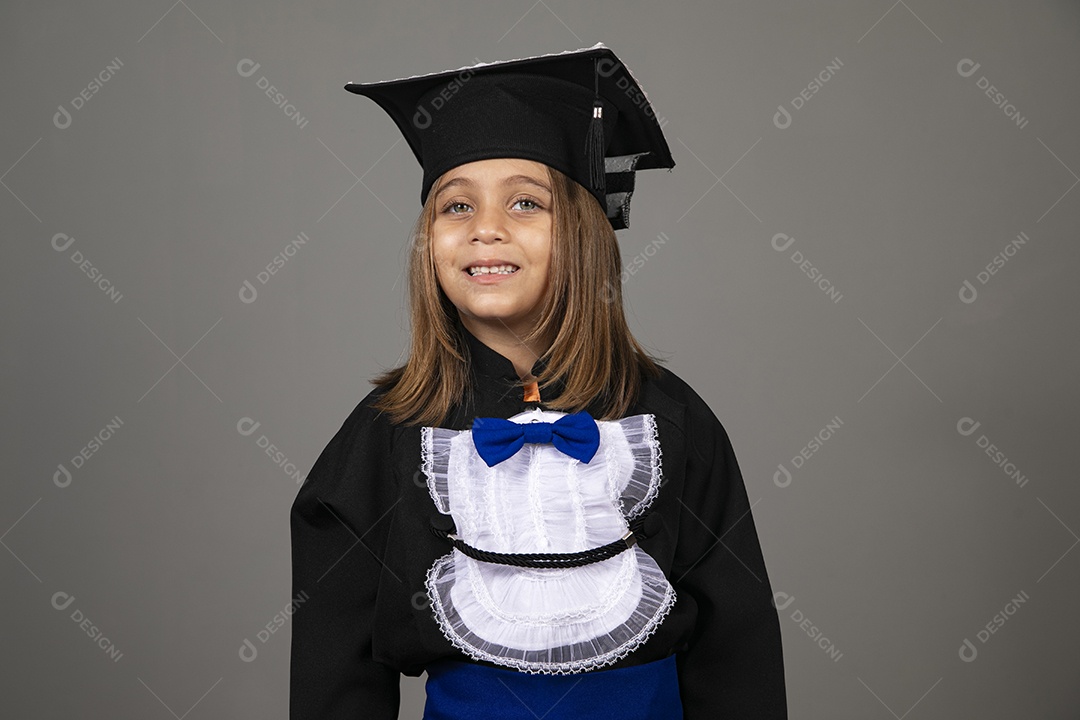 Beautiful little girl using graduation beak