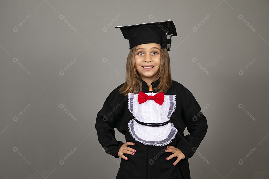 Beautiful little girl using graduation beak